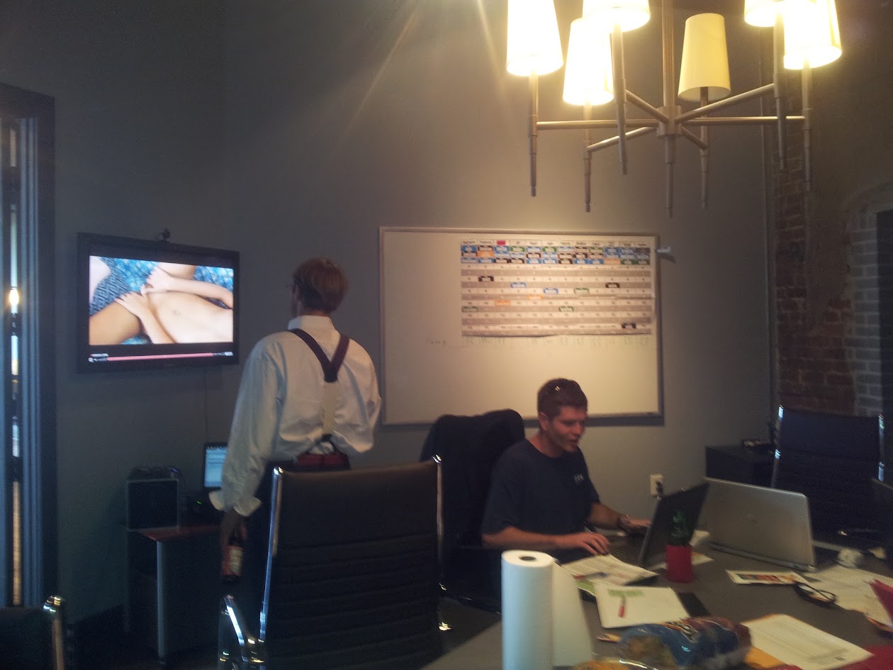 Two HFFL owners in the 2012 draft room with the physical draft board behind them